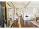 Welcoming entryway with gleaming hardwood floors, paneled walls, and an elegant full-length mirror at 4710 Robins Nest Ln, Cumming, GA 30041