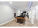 Basement game room featuring a stylish billiard table, TV area, and recessed lighting at 4710 Robins Nest Ln, Cumming, GA 30041