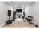 Home gym featuring weight machines, heavy bag, TV, and recessed lighting at 4710 Robins Nest Ln, Cumming, GA 30041