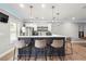 This modern kitchen features stainless steel appliances, pendant lighting, and bar seating, perfect for entertaining at 4710 Robins Nest Ln, Cumming, GA 30041