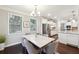Eat-in kitchen featuring granite countertops, stainless steel appliances, white cabinets, and ample counter space at 4710 Robins Nest Ln, Cumming, GA 30041