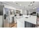 Modern kitchen with stainless steel appliances, white cabinets, and ample countertop space at 4710 Robins Nest Ln, Cumming, GA 30041