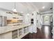 Bright kitchen with stainless steel appliances and granite countertops and open shelving at 4710 Robins Nest Ln, Cumming, GA 30041