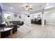 Spacious living room featuring a modern design with a sleek leather sofa and open bar at 4710 Robins Nest Ln, Cumming, GA 30041