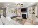 Comfortable living room with a fireplace, built-in shelving, and large windows for natural light at 4710 Robins Nest Ln, Cumming, GA 30041