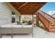 This cozy covered patio has outdoor seating and string lights, perfect for relaxing and entertaining at 4710 Robins Nest Ln, Cumming, GA 30041