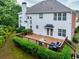 Aerial view of the backyard featuring a large deck, manicured hedges, and a lush green lawn at 4203 Norbury Ct, Smyrna, GA 30080