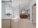 This is a tiled bathroom with tub, glass shower, and vanity at 4203 Norbury Ct, Smyrna, GA 30080
