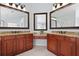 Bathroom featuring double vanity with framed mirrors and granite countertops at 4203 Norbury Ct, Smyrna, GA 30080