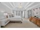 Primary bedroom with a tray ceiling, plush carpet, and ensuite bathroom at 4203 Norbury Ct, Smyrna, GA 30080