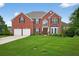 Charming two-story brick home with a lush green lawn, complemented by mature trees at 4203 Norbury Ct, Smyrna, GA 30080