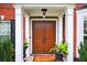 Inviting front entrance with elegant double doors, flanked by white columns and potted plants at 4203 Norbury Ct, Smyrna, GA 30080