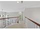 Well-lit hallway with carpet floors and elegant railing detail at 4203 Norbury Ct, Smyrna, GA 30080