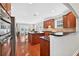 Well-lit kitchen featuring hardwood floors, stainless steel appliances, granite countertops, and a spacious island at 4203 Norbury Ct, Smyrna, GA 30080