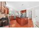 Beautiful kitchen with cherry cabinets, granite countertops, stainless appliances, kitchen island, and hardwood floors at 4203 Norbury Ct, Smyrna, GA 30080
