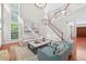 Bright and airy living room with tall windows and elegant staircase at 4203 Norbury Ct, Smyrna, GA 30080