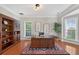 Bright office featuring hardwood floors, built-in bookshelves, and a spacious desk at 4203 Norbury Ct, Smyrna, GA 30080