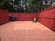 Private patio area featuring a red-stained wooden fence and tile flooring at 4645 Valais Ct # 10, Johns Creek, GA 30022