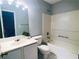 Well-lit full bathroom with white tiles, combined tub and shower, and ample vanity space at 4645 Valais Ct # 10, Johns Creek, GA 30022