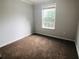 Comfortable bedroom featuring a large window, plush carpeting and neutral walls creating a relaxing atmosphere at 4645 Valais Ct # 10, Johns Creek, GA 30022
