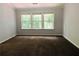 Spacious bedroom featuring carpet, neutral walls and a large window that offers natural light at 4645 Valais Ct # 10, Johns Creek, GA 30022