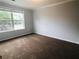 Cozy bedroom with a large window, plush carpeting and neutral walls creating a relaxing atmosphere at 4645 Valais Ct # 10, Johns Creek, GA 30022