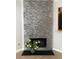 Close-up of the stone fireplace and hearth, accessorized with a vase of flowers at 4645 Valais Ct # 10, Johns Creek, GA 30022