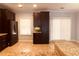 Open-concept kitchen with dark cabinetry, stainless steel refrigerator, and granite-topped island at 4645 Valais Ct # 10, Johns Creek, GA 30022