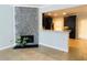Living room features tile flooring, gray walls, a fireplace with stone detail, and an open kitchen view at 4645 Valais Ct # 10, Johns Creek, GA 30022