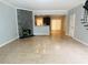Bright living room with tile floors, fireplace with stone accent wall, and open concept to the kitchen at 4645 Valais Ct # 10, Johns Creek, GA 30022