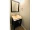 Elegant powder room featuring a pedestal sink, stylish mirror, and modern fixtures at 4645 Valais Ct # 10, Johns Creek, GA 30022