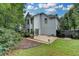 Back of house view highlighting the backyard, patio, and a glimpse of the home's architecture at 5015 Riverthur Pl, Peachtree Corners, GA 30096