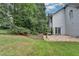 Exterior of the house showing a brick patio surrounded by a lush green lawn at 5015 Riverthur Pl, Peachtree Corners, GA 30096