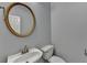 Powder room features modern fixtures, a gold round mirror, and a pedestal sink at 5015 Riverthur Pl, Peachtree Corners, GA 30096