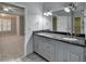 Bright bathroom featuring a double granite vanity and an open view into a bedroom area at 5015 Riverthur Pl, Peachtree Corners, GA 30096