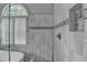 Luxury bathroom features a soaking tub with an arched window and a frameless shower at 5015 Riverthur Pl, Peachtree Corners, GA 30096