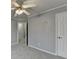 Gray painted bedroom shows neutral carpet, an open doorway, and classic white trim at 5015 Riverthur Pl, Peachtree Corners, GA 30096