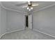 Corner of gray bedroom shows light-gray walls, neutral carpet, ceiling fan, and a white door at 5015 Riverthur Pl, Peachtree Corners, GA 30096