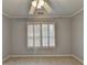 Window view in the bedroom features bright light coming through plantation shutters and neutral carpet at 5015 Riverthur Pl, Peachtree Corners, GA 30096