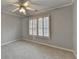 Neutral bedroom showcasing light-gray walls, a ceiling fan, and white plantation shutters on the window at 5015 Riverthur Pl, Peachtree Corners, GA 30096