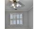 Bright bedroom featuring light-gray walls, plush carpet, and plantation shutters on the window at 5015 Riverthur Pl, Peachtree Corners, GA 30096