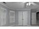 Bedroom featuring a ceiling fan, windows with white shutters, and double door closet at 5015 Riverthur Pl, Peachtree Corners, GA 30096