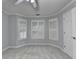 Bright bedroom with neutral walls, carpet floors, and windows with wooden shutters at 5015 Riverthur Pl, Peachtree Corners, GA 30096