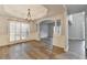 Spacious dining area with hardwood floors, tray ceiling, chandelier, and white columns at 5015 Riverthur Pl, Peachtree Corners, GA 30096
