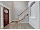 Bright foyer featuring hardwood floors, stairs with white spindles and wood railing, and a decorative front door at 5015 Riverthur Pl, Peachtree Corners, GA 30096