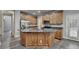 Large, bright kitchen featuring an island, stainless steel appliances, granite countertops, and wood cabinets at 5015 Riverthur Pl, Peachtree Corners, GA 30096