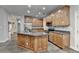 Spacious kitchen featuring a large island, wood cabinets, stainless steel appliances, and granite countertops at 5015 Riverthur Pl, Peachtree Corners, GA 30096