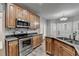Gourmet kitchen with stainless steel appliances, granite countertops, custom cabinets and hardwood floors at 5015 Riverthur Pl, Peachtree Corners, GA 30096