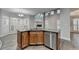 Open-concept kitchen with an island, wooden cabinets, stainless steel dishwasher and granite countertops at 5015 Riverthur Pl, Peachtree Corners, GA 30096