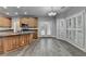 Spacious kitchen with wooden cabinets, granite countertops, island, stainless steel appliances and hardwood floors at 5015 Riverthur Pl, Peachtree Corners, GA 30096